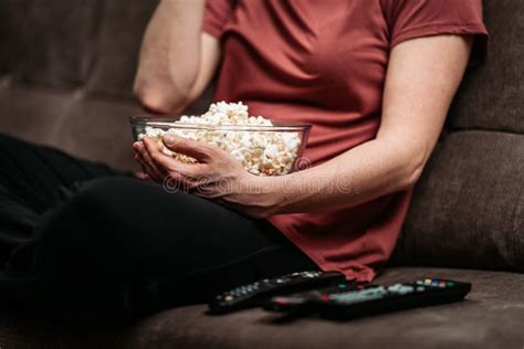 Cozy movie night setup with popcorn and remote